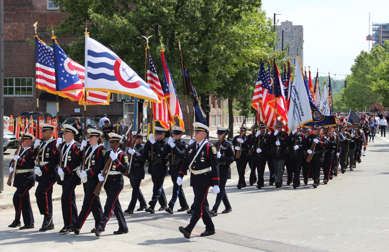 Departmental color guards march along Central Parkway.